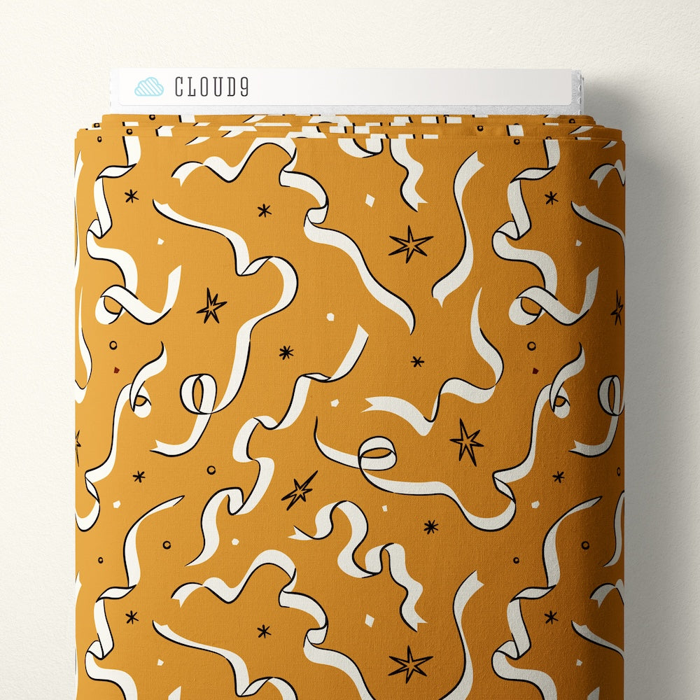 Pattern of white ribbons and stars on a mustard yellow background
