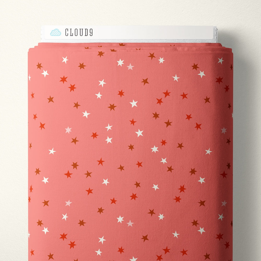 Pattern of red, white, and brown stars on a pink background