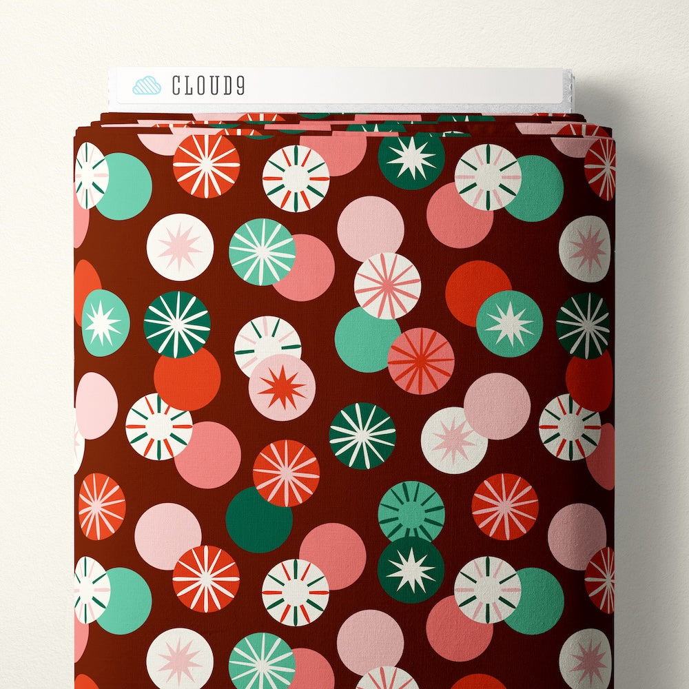 Pattern of colorful circle candies on a red brown background