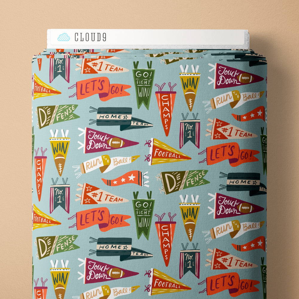 Pattern of colorful football-themed pennants on a blue background, fabric