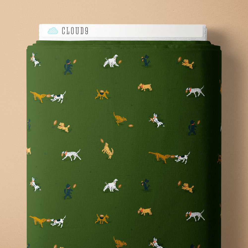 Pattern of dogs playing with a ball on a green background fabric