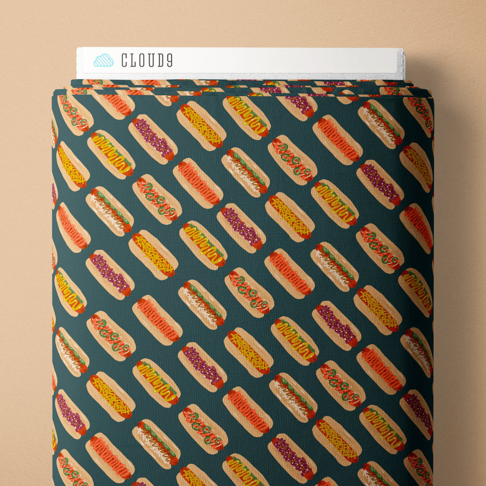 Pattern of hot dogs with various toppings on a teal background fabric