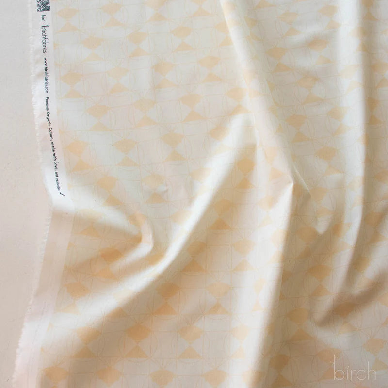 Patterned fabric with a geometric design on an off white background