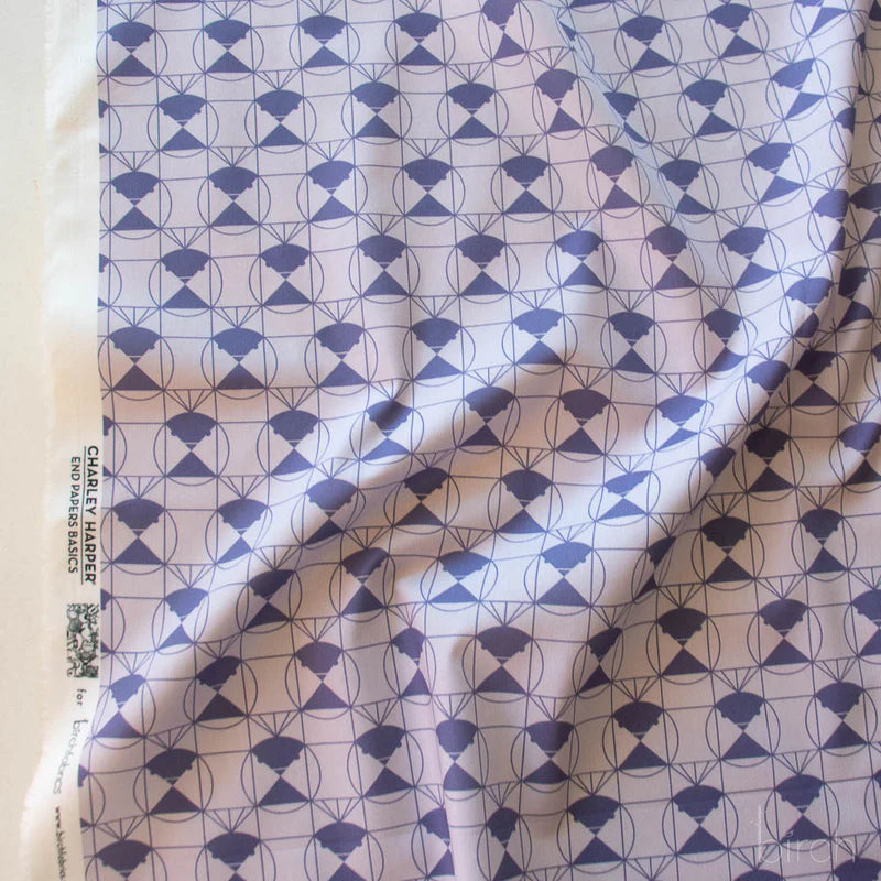 Patterned fabric with a purple geometric design on a light purple background