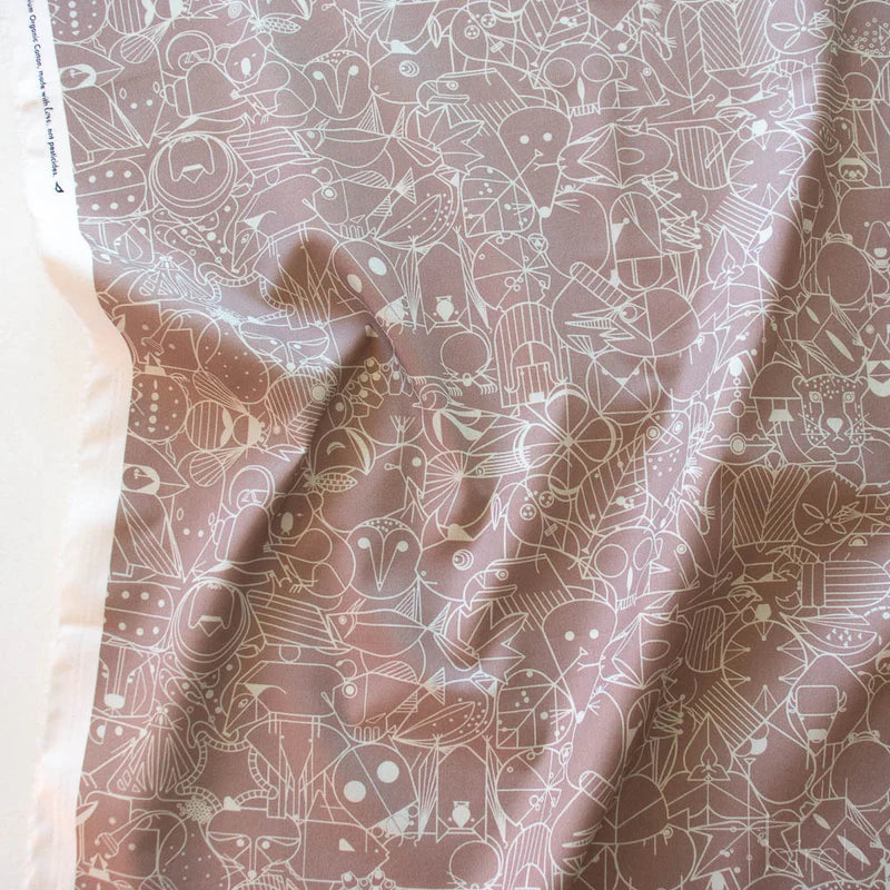Patterned fabric with geometric animal illustrations in beige on a medium brown background