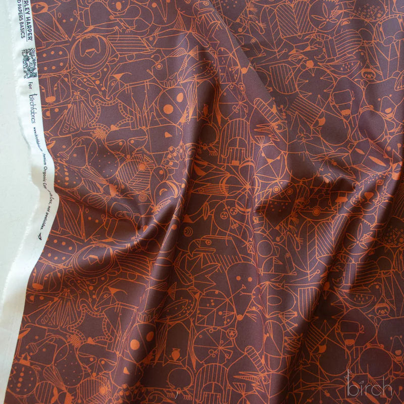Patterned fabric with geometric animal illustrations in brown on a brown background