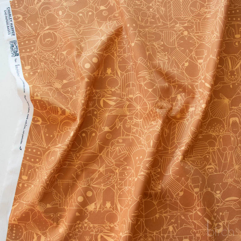 Patterned fabric with geometric animal illustrations in light orange on a orange-brown background