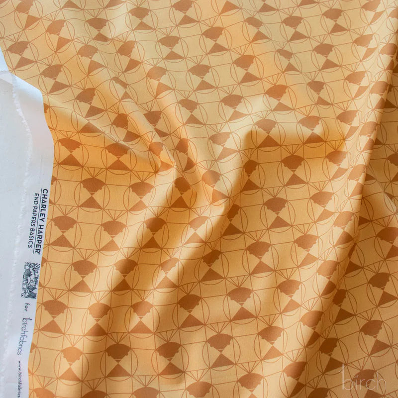 Patterned fabric with a orange-brown geometric design on a lighter orange-brown background