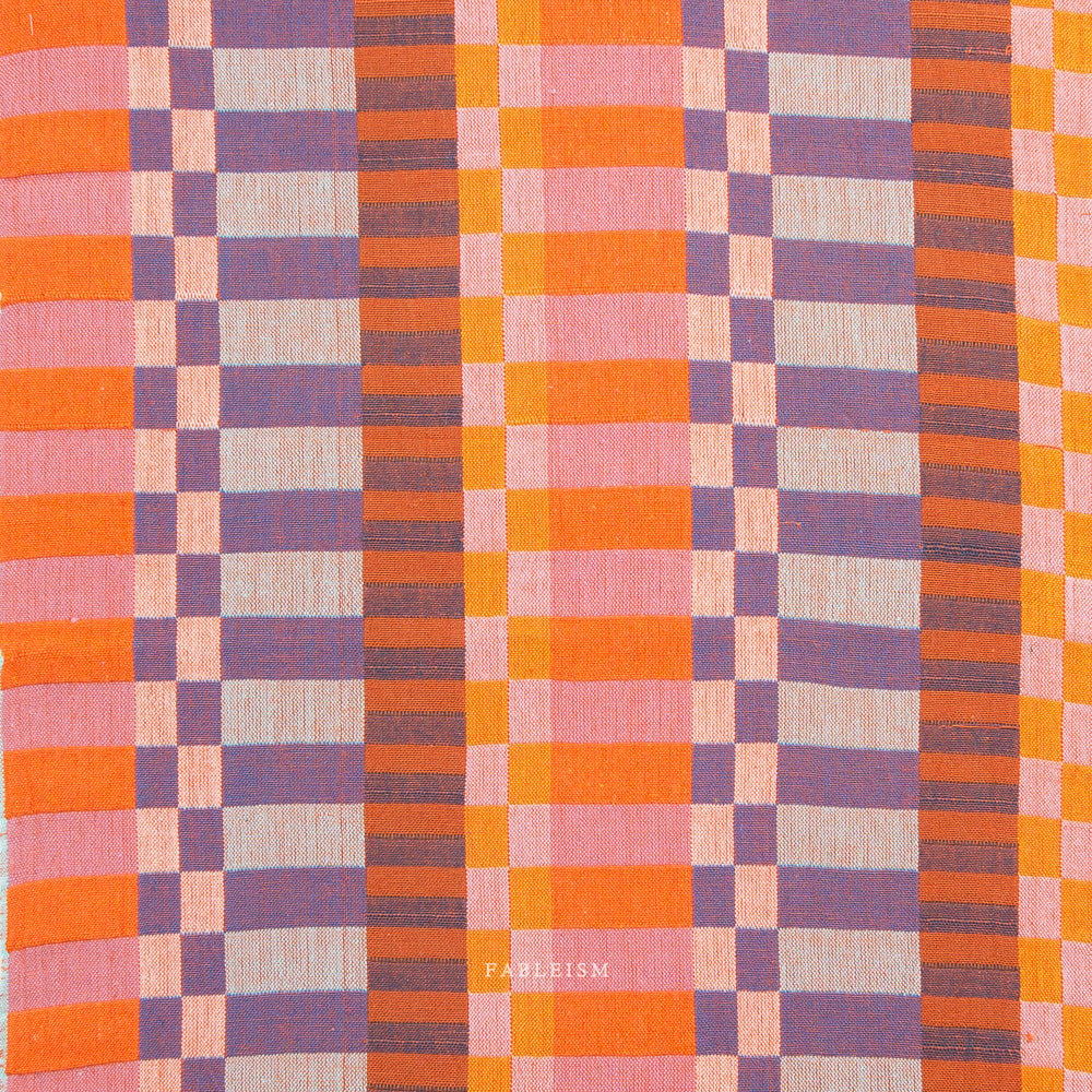 Checkered fabric with orange, purple, and pink colors on a white background