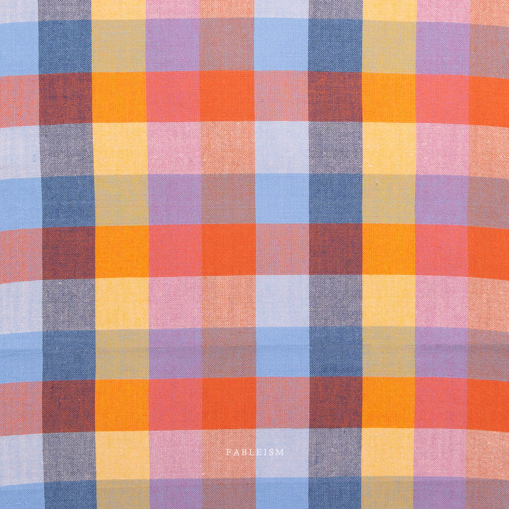 Multicolored checkered fabric with 'Fableism' branding on a white background