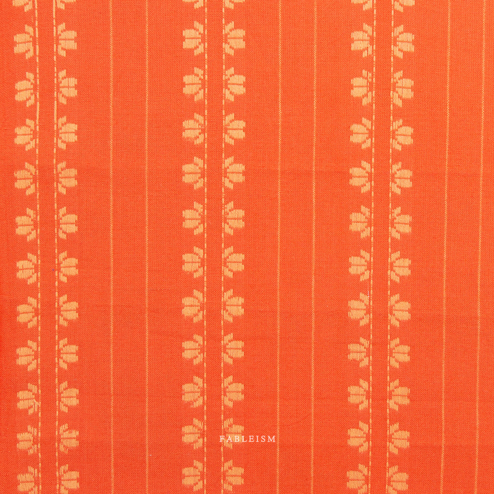 Orange fabric with light orange floral stripes on a light gray background