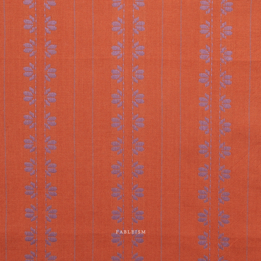 Orange fabric with purple floral stripe pattern, on a white background