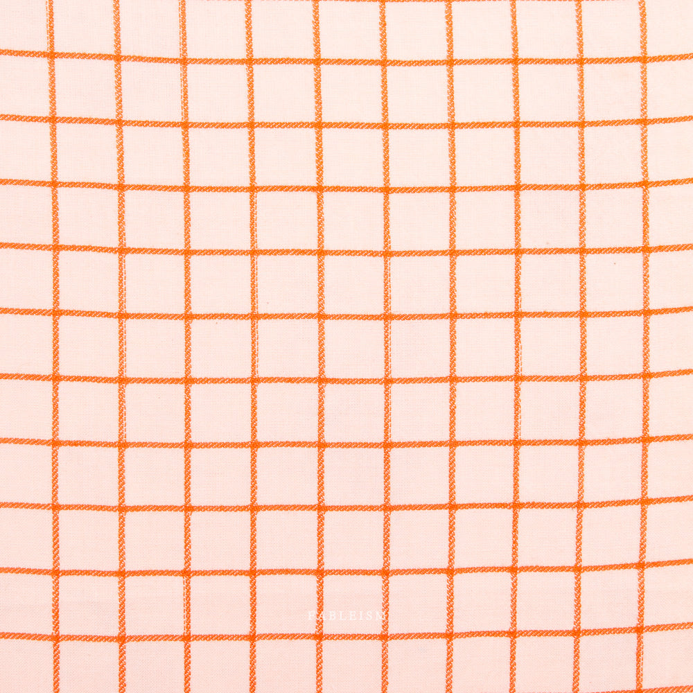 Pink fabric with orange grid pattern on a white background