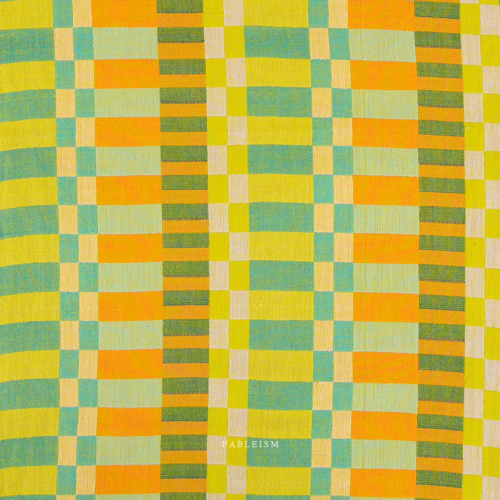 Checkered fabric with green and orange pattern on a white background