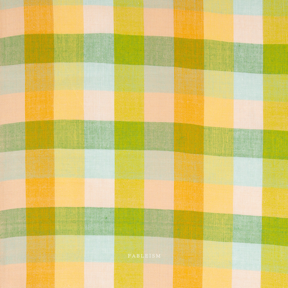 Green, orange, and yellow checkered fabric with 'Fableism' branding on a white background