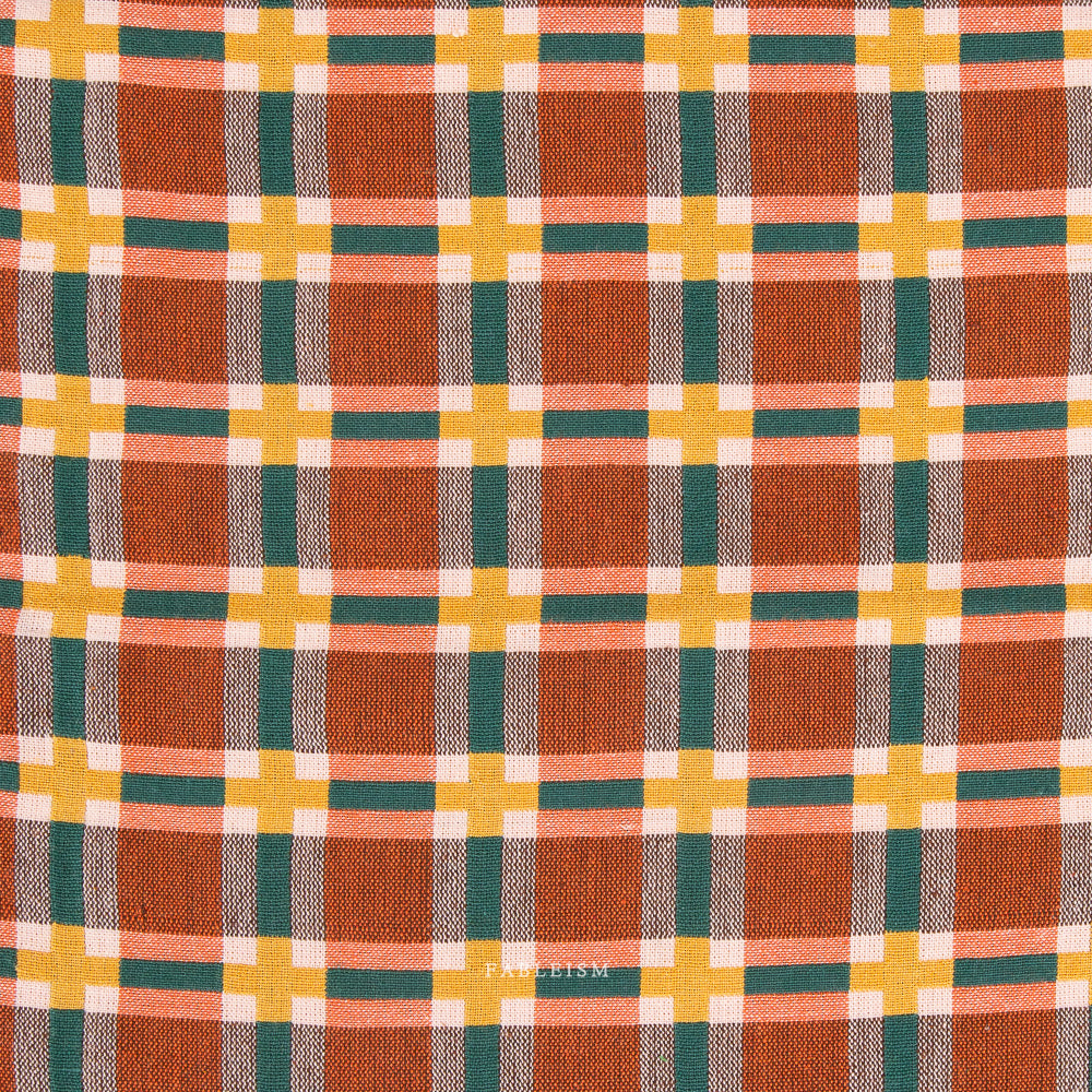 Plaid fabric with orange, yellow, and green pattern on a white background