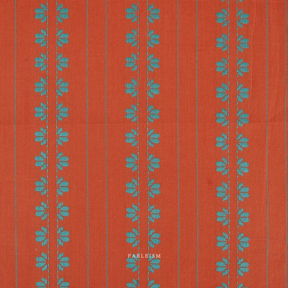 Orange fabric with turquoise floral pattern on a white background