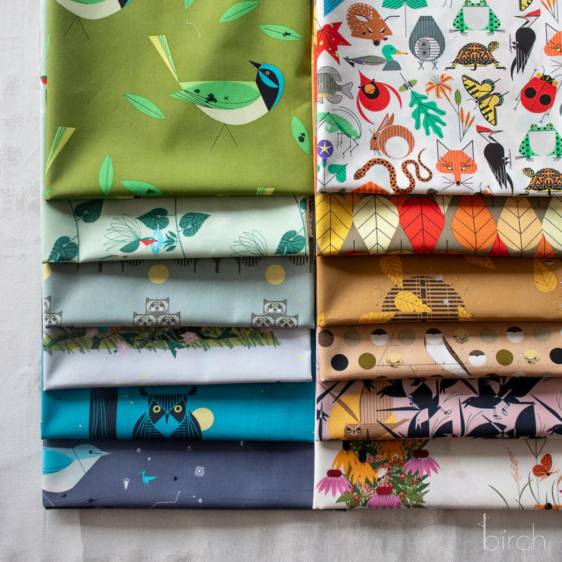 Collection of colorful, modern, nature inspired fabrics with various patterns on a neutral background.