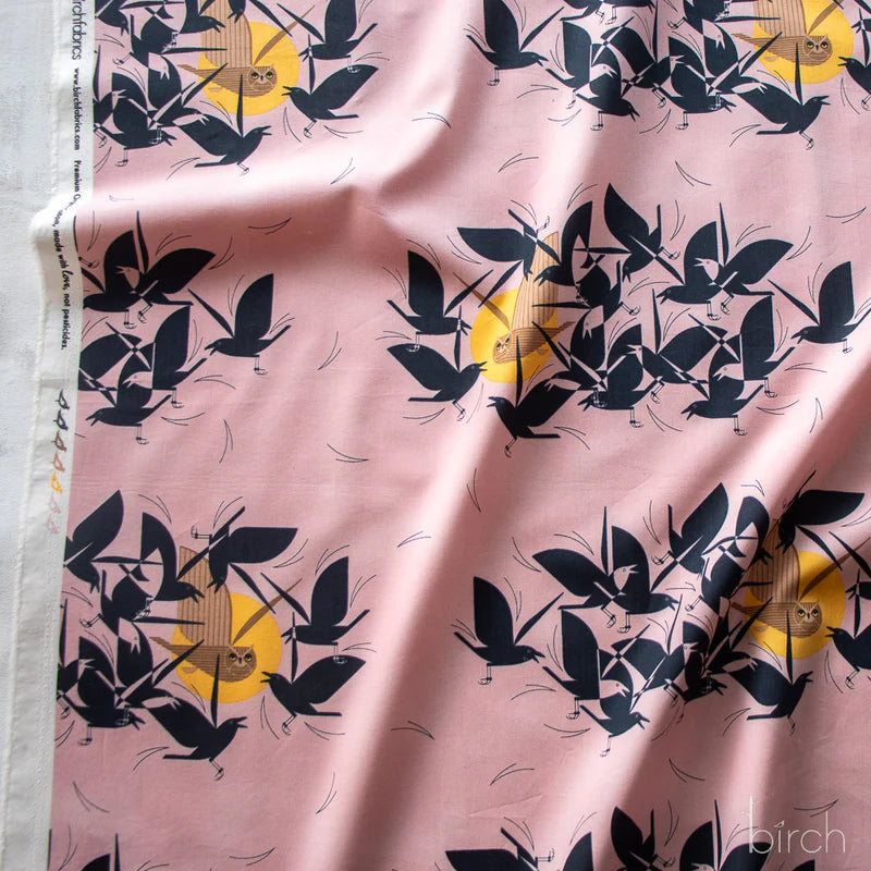 Pattern of black birds and yellow circles on a pink background