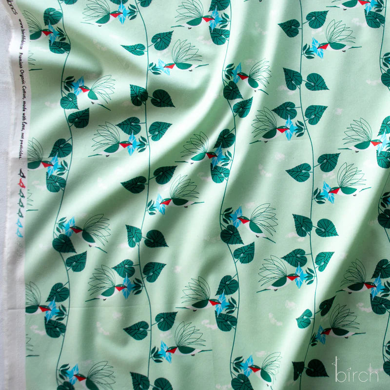 Fabric pattern with birds and leaves on a light green background