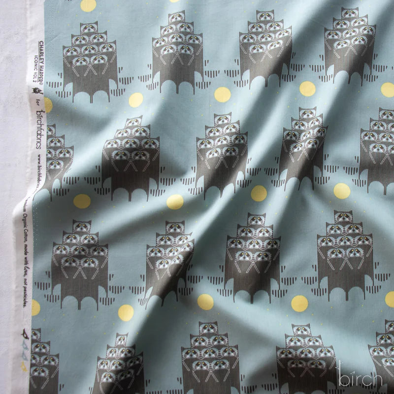 Pattern of stacked raccoons on a blue gray background with a yellow moon.