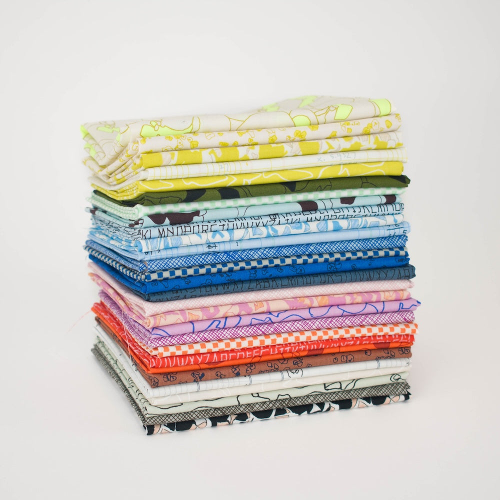 A circular arrangement of folded fabric swatches in many colors and abstract patterns, displayed on a white background.