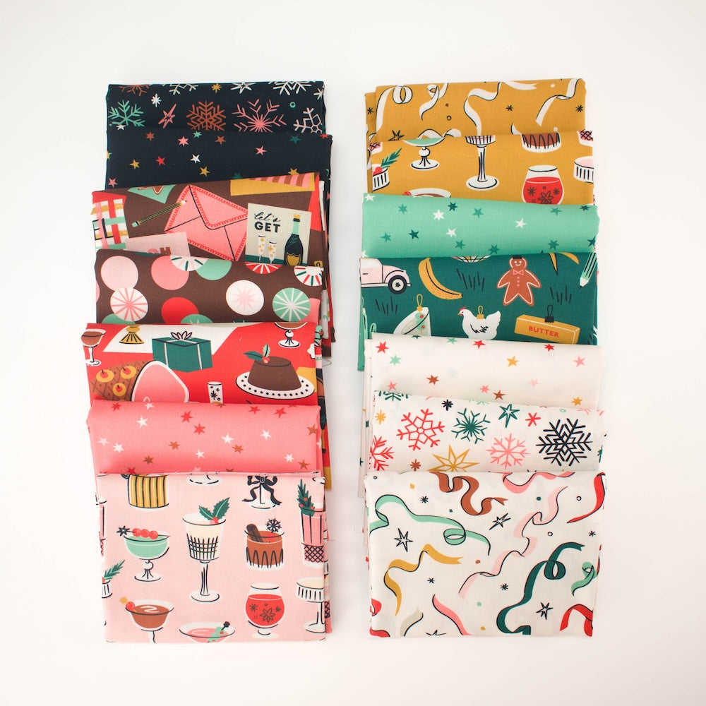 A stack of folded fabric pieces with various holiday-themed patterns, including cocktails, snowflakes, stars, candy, and ornaments, set against a plain white background.