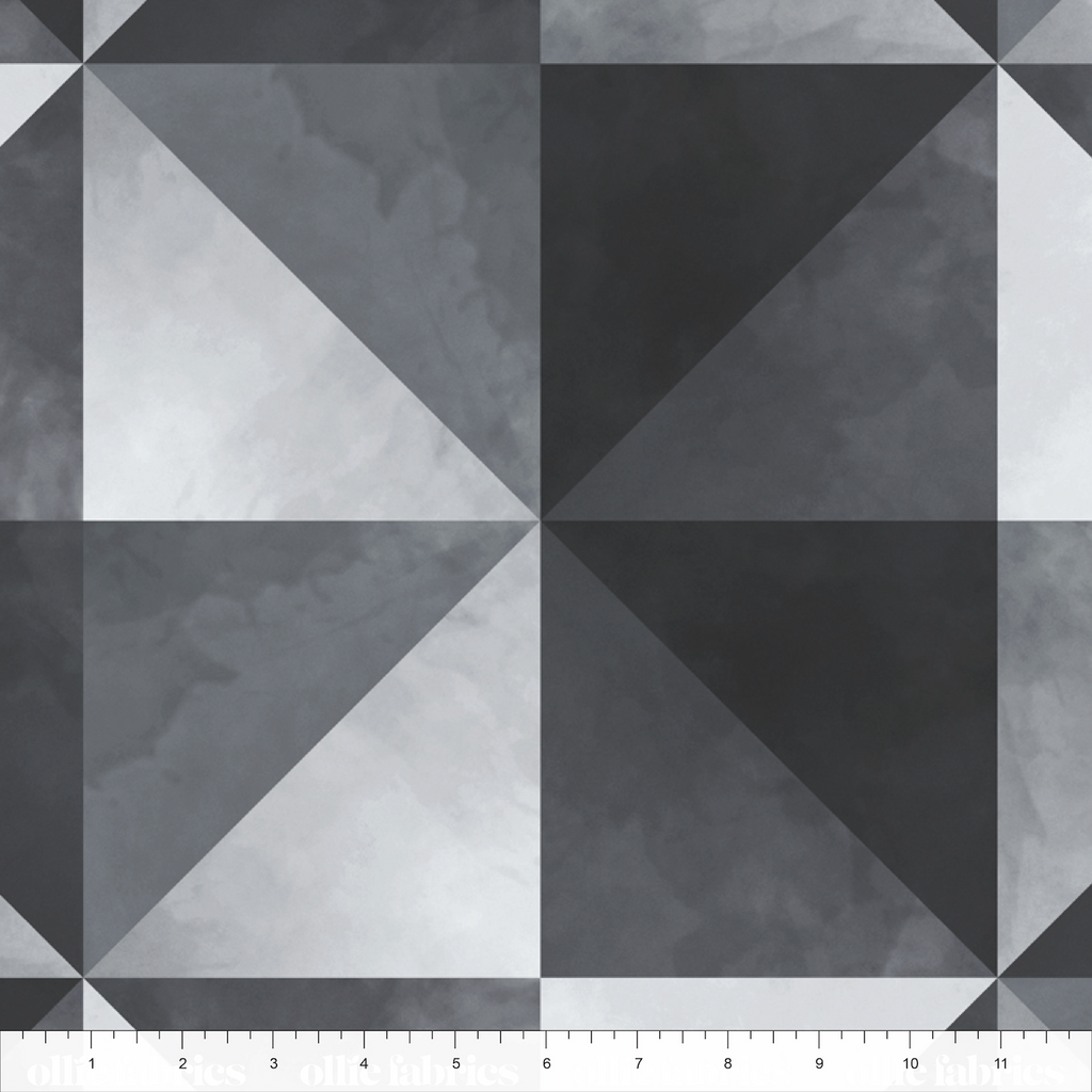 Geometric pattern of triangles in black, white, and gray on a textured surface.