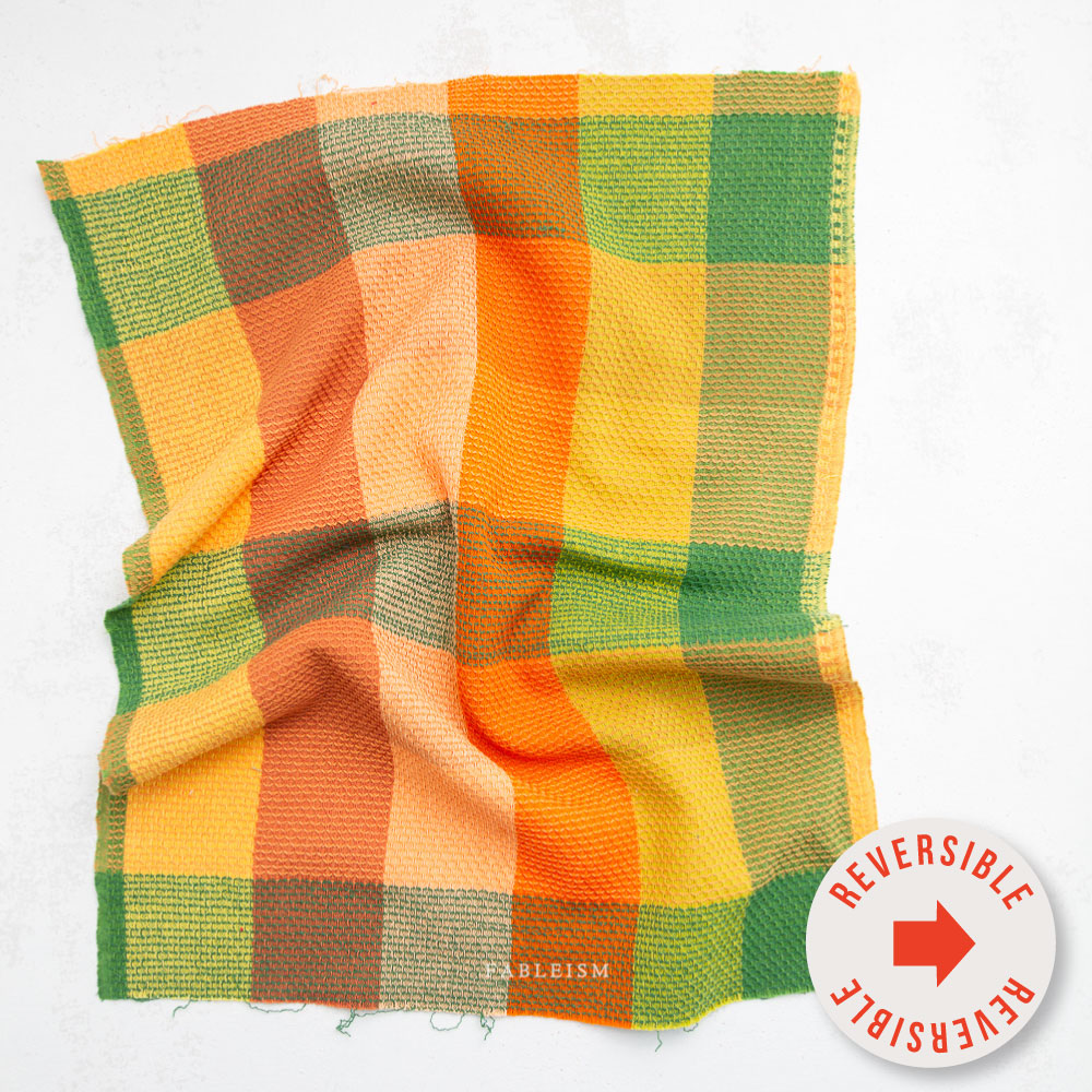 Close-up of a checkered fabric with orange, yellow, and green colors.