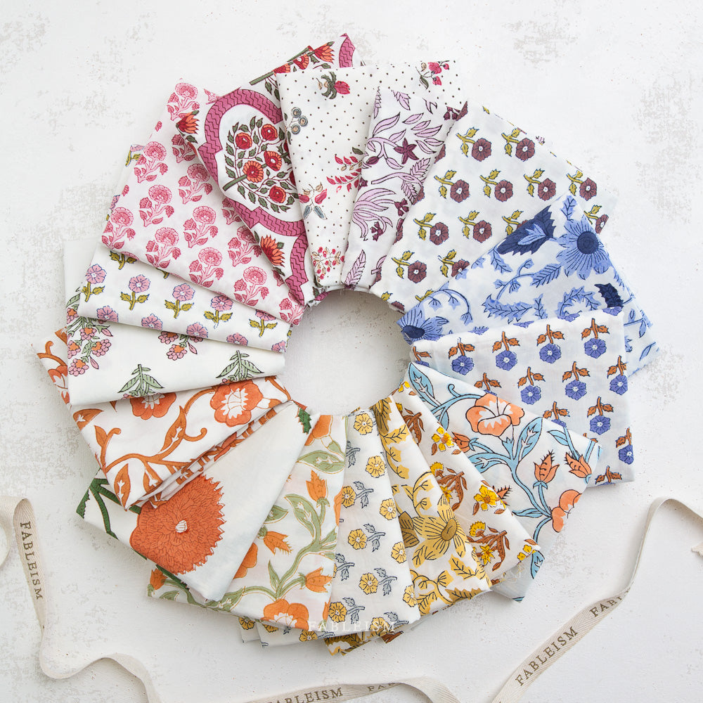 Stack of colorful fabric squares on a white background